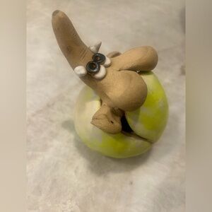 Ceramic elephant in a tennis ball by Lenore Atwood - signed